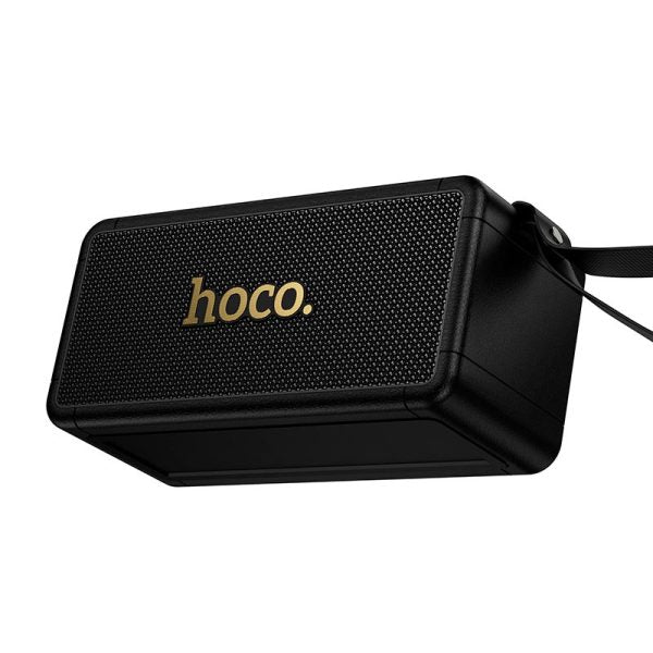 Parlante HOCO HT1 Max negro en ángulo, malla metálica y logo dorado