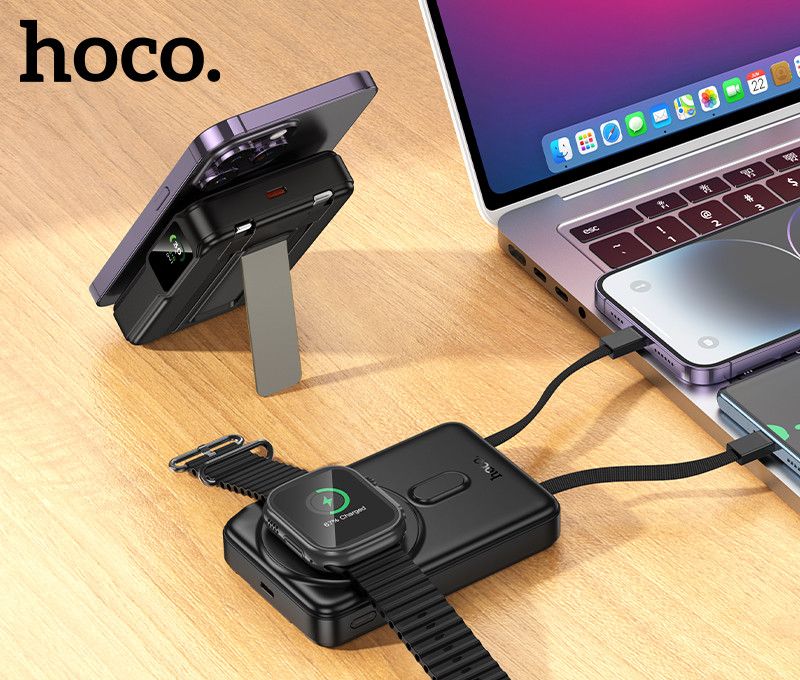 HOCO Q48 Core cargando un iPhone y un Apple Watch junto a un notebook